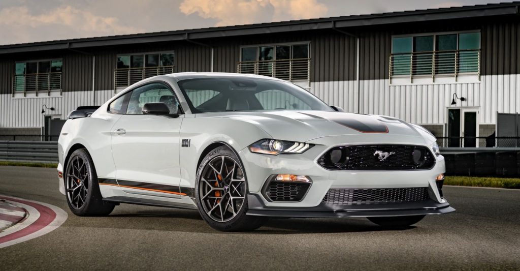 A white with a black and orange striped 2021 Ford Mustang parked on a track. | Ford dealer in Little Rock, AR.