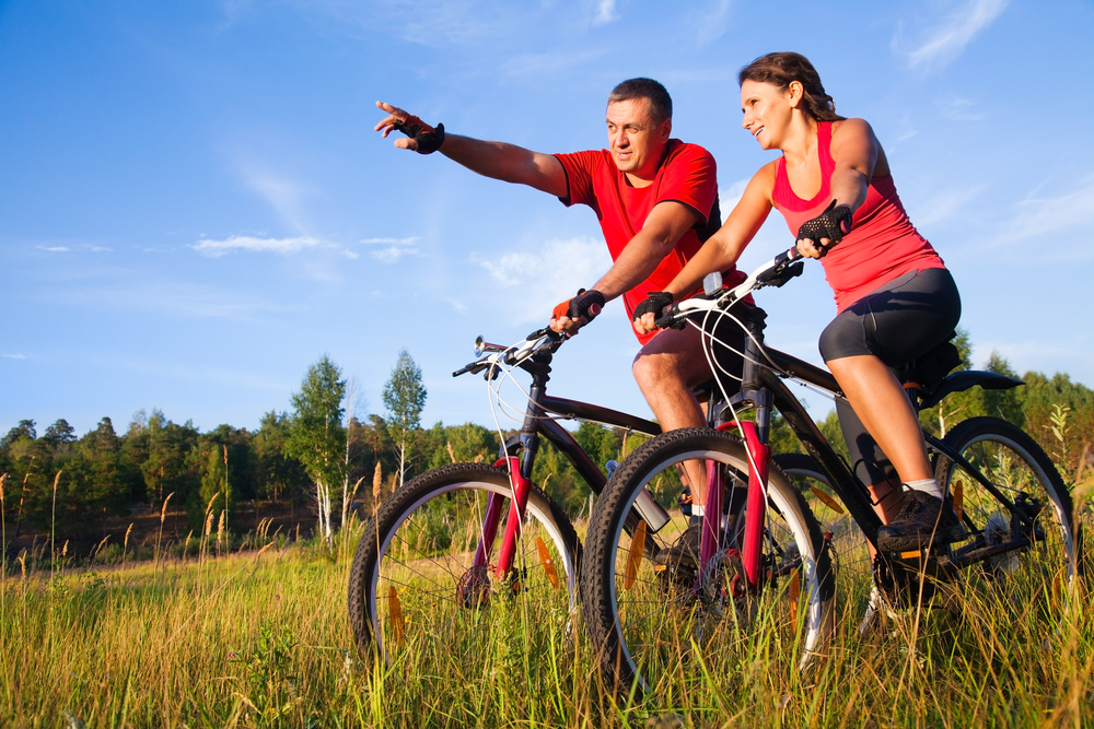 A man and woman on bikes in a park. | Biking near Little Rock, AR.