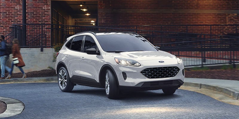 A white 2021 Ford Escape parked in front of a brick building. | Ford dealer in Little Rock, AR.