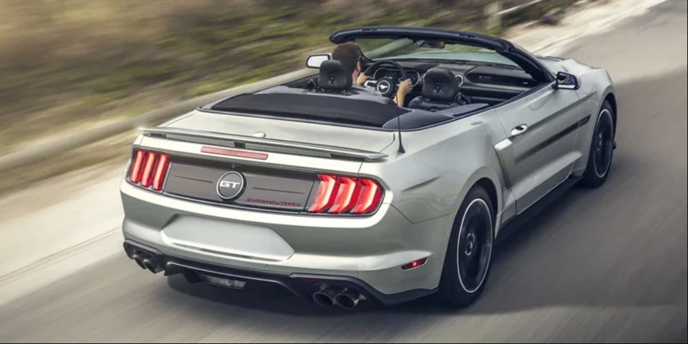 Rear view of a silver 2022 Ford Mustang being driven on the highway. | Ford dealer in Little Rock, AR.