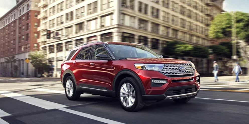 Profile view of a red 2022 Ford Explorer being driven on the highway. | Ford dealer in Little Rock, AR.