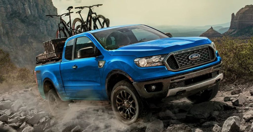 Bright blue 2023 Ford Ranger being driven on rocky terrain surrounded by mountains. | Ford dealer in Little Rock, AR. 