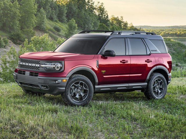 Profile view of a burgundy, 2023 Bronco Sport parked in a wooded area. | Ford dealer in Little Rock, AR.