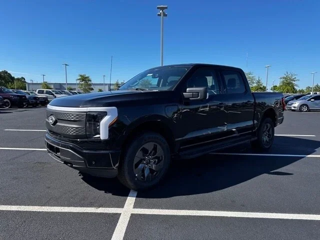 Black Ford F-150 Lightning in a car lot